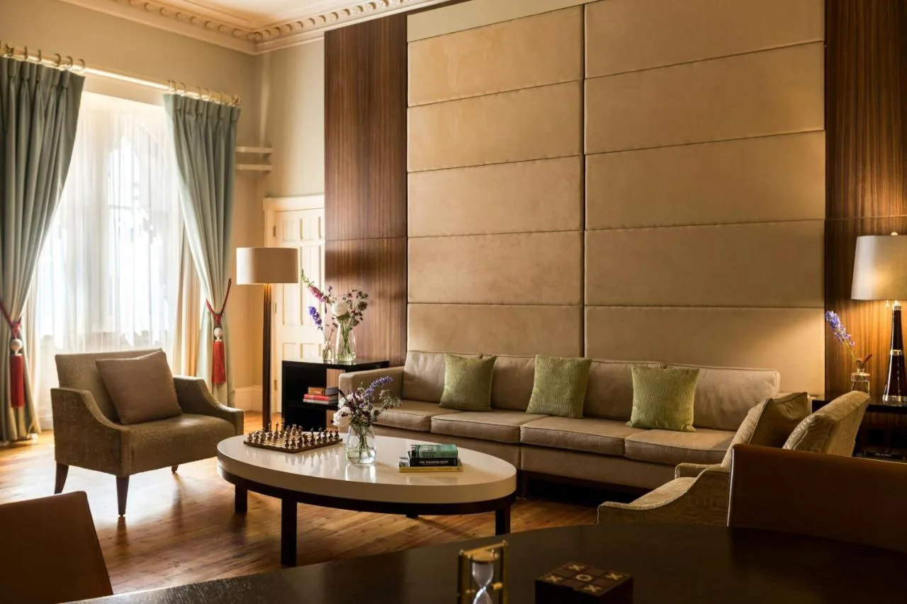 a living room with a couch and a table at St Pancras London, Autograph Collection
