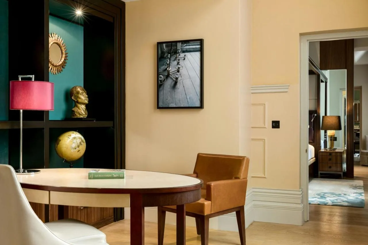 a living room with a table and a chair at St Pancras London, Autograph Collection
